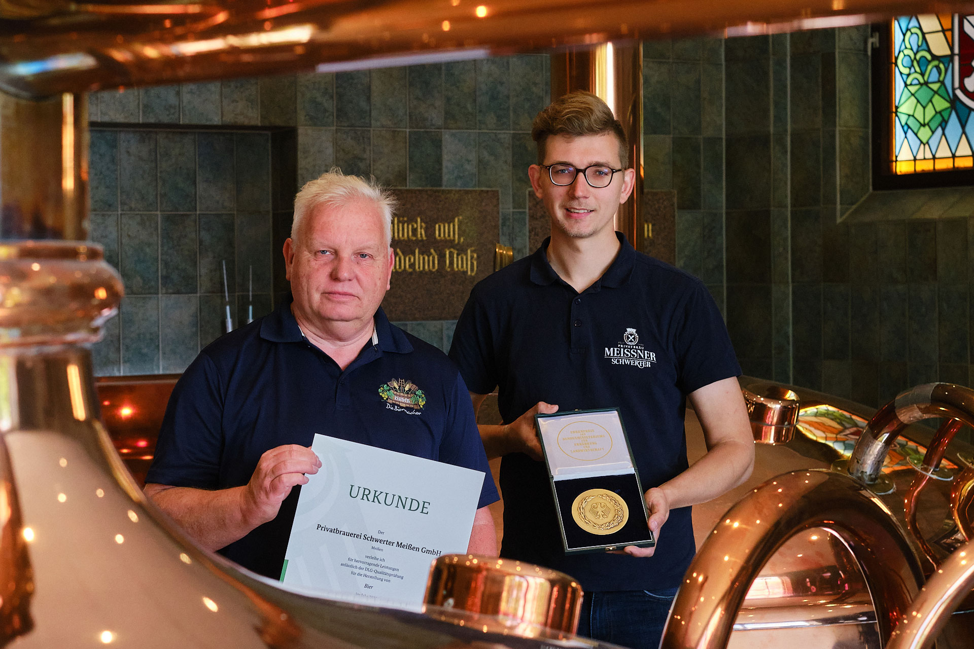 Braumeister Bernd Heitmann (links) und Brauer Oliver Herzog präsentieren stolz den Bundesehrenpreis, die höchste Ehrung der deutschen Ernährungswirtschaft.